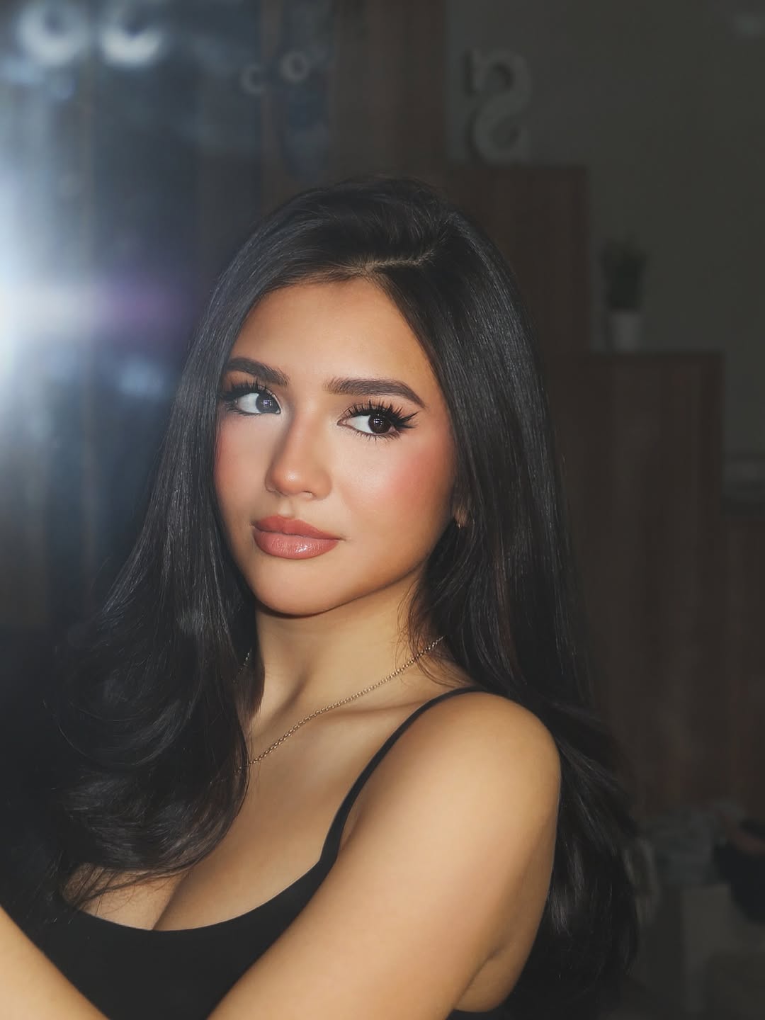 Sabrina Cuervo close-up selfie in a black hoodie