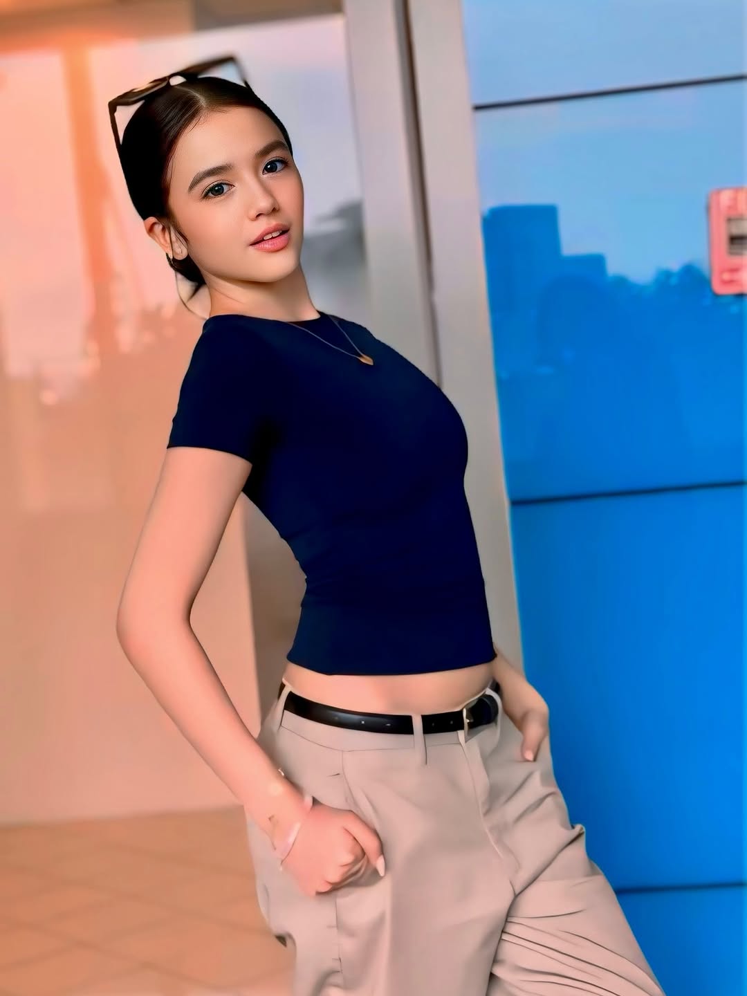 Sabrina Cuervo in a white shirt and dark trousers on a city street